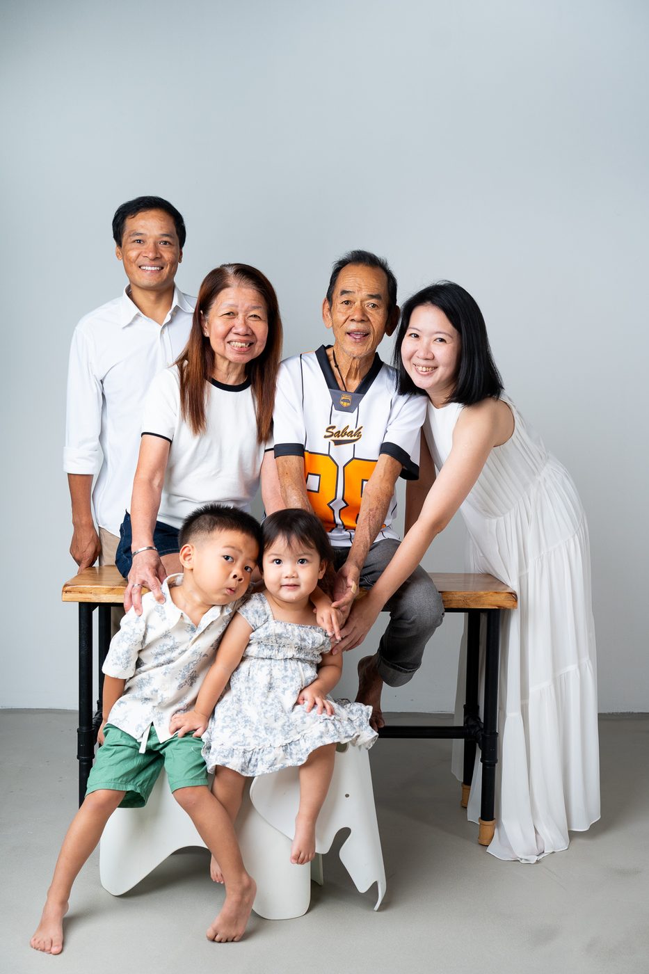 Multi-generational family portrait Singapore — grandparents and grandchildren studio photoshoot