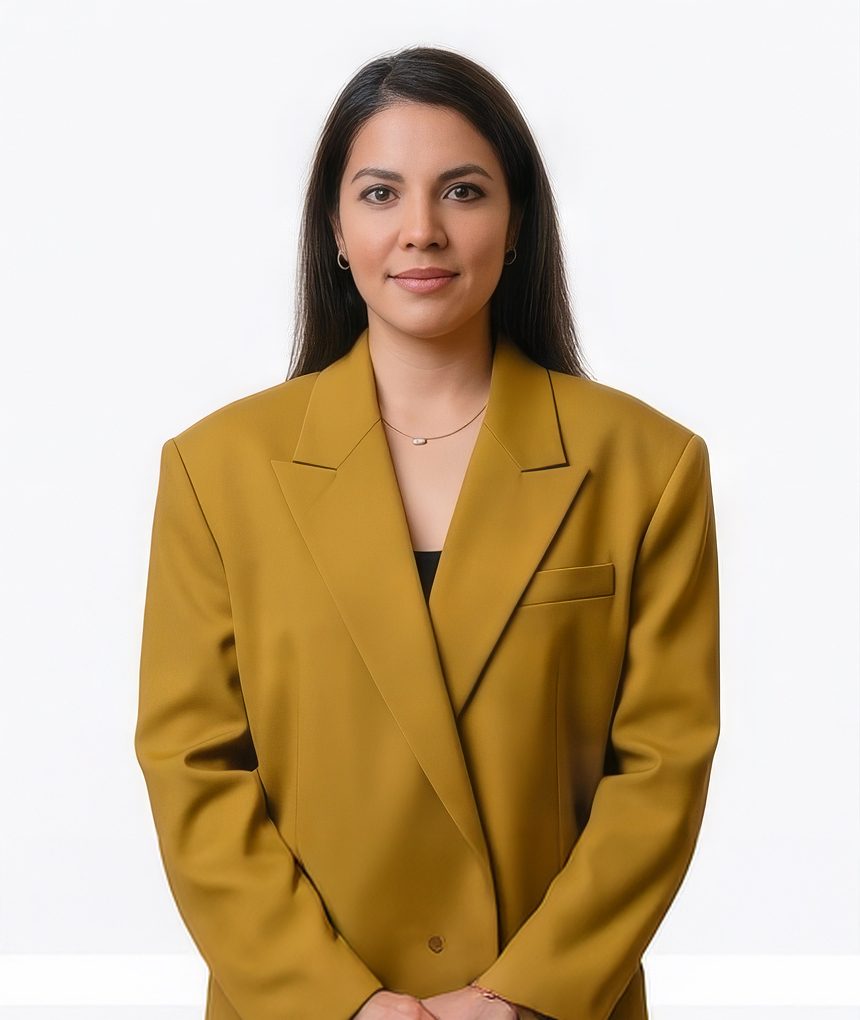 Woman in a burnt orange coat with statement earrings for a creative LinkedIn headshot