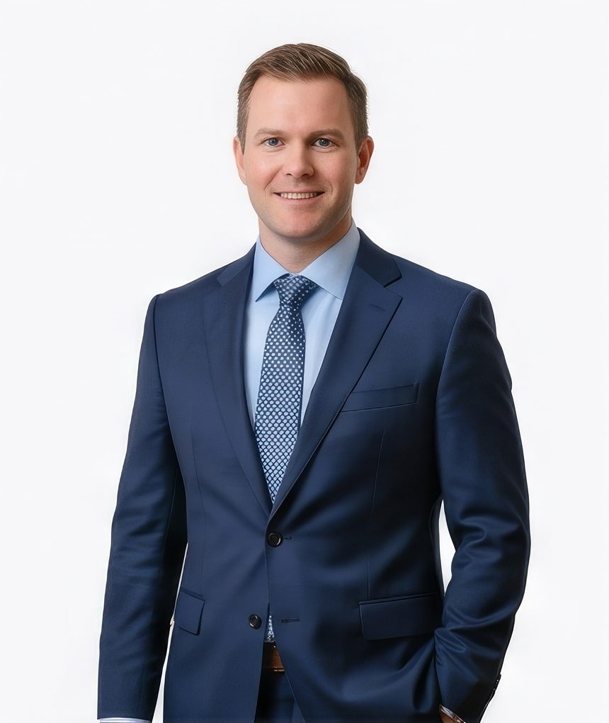 Man in a navy suit and patterned tie for a finance LinkedIn headshot