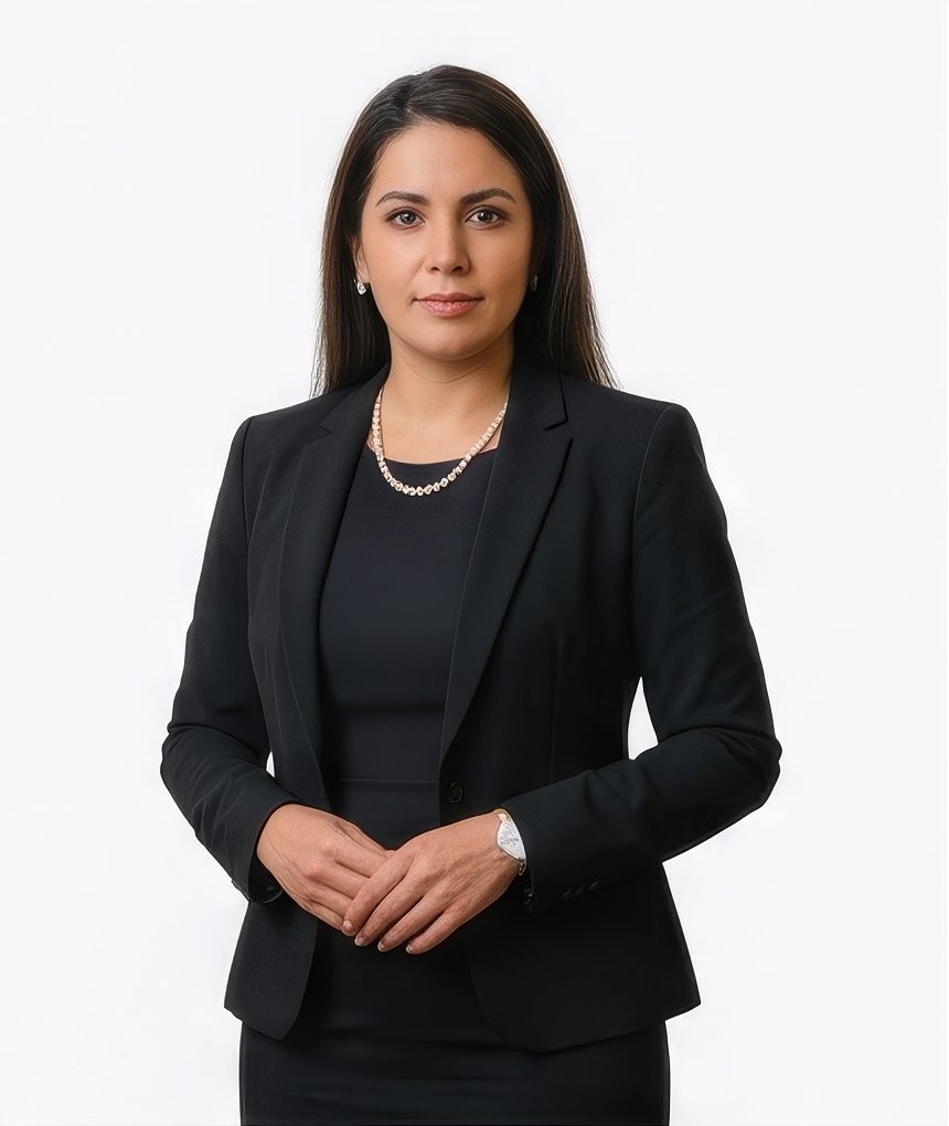 Woman in a black dress and blazer with a necklace for a finance LinkedIn headshot