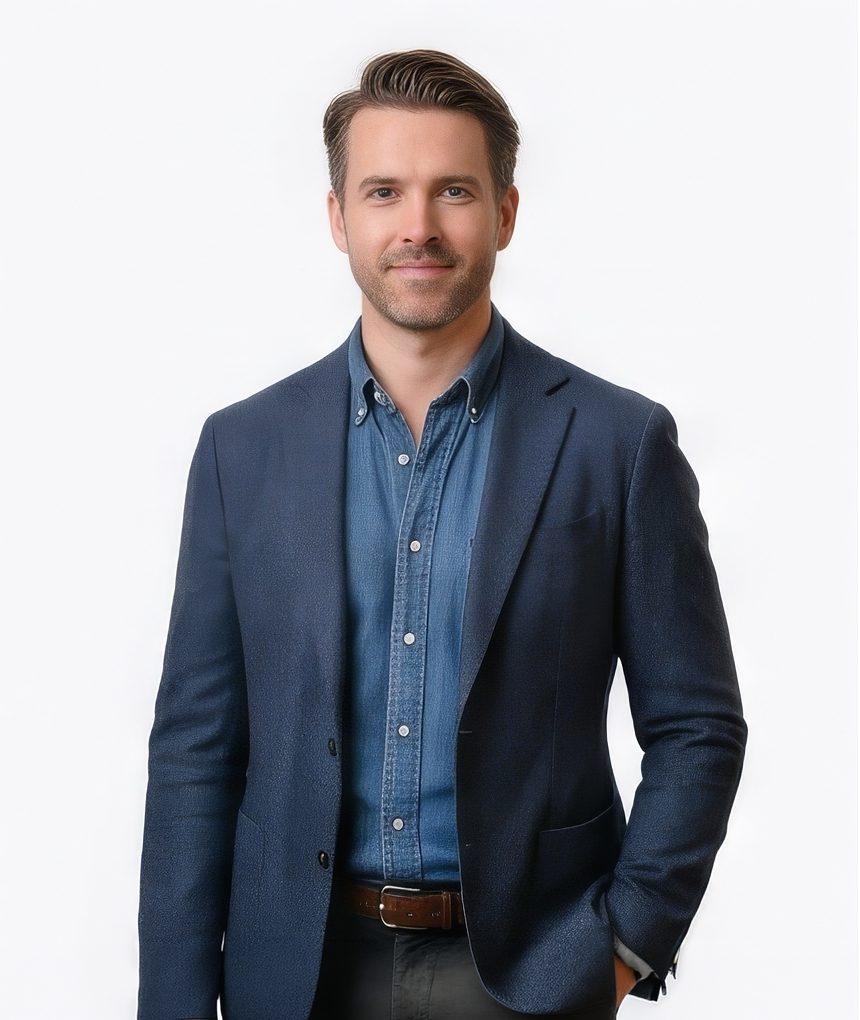Man in a v-neck sweater with patterned shirt for a tech LinkedIn headshot